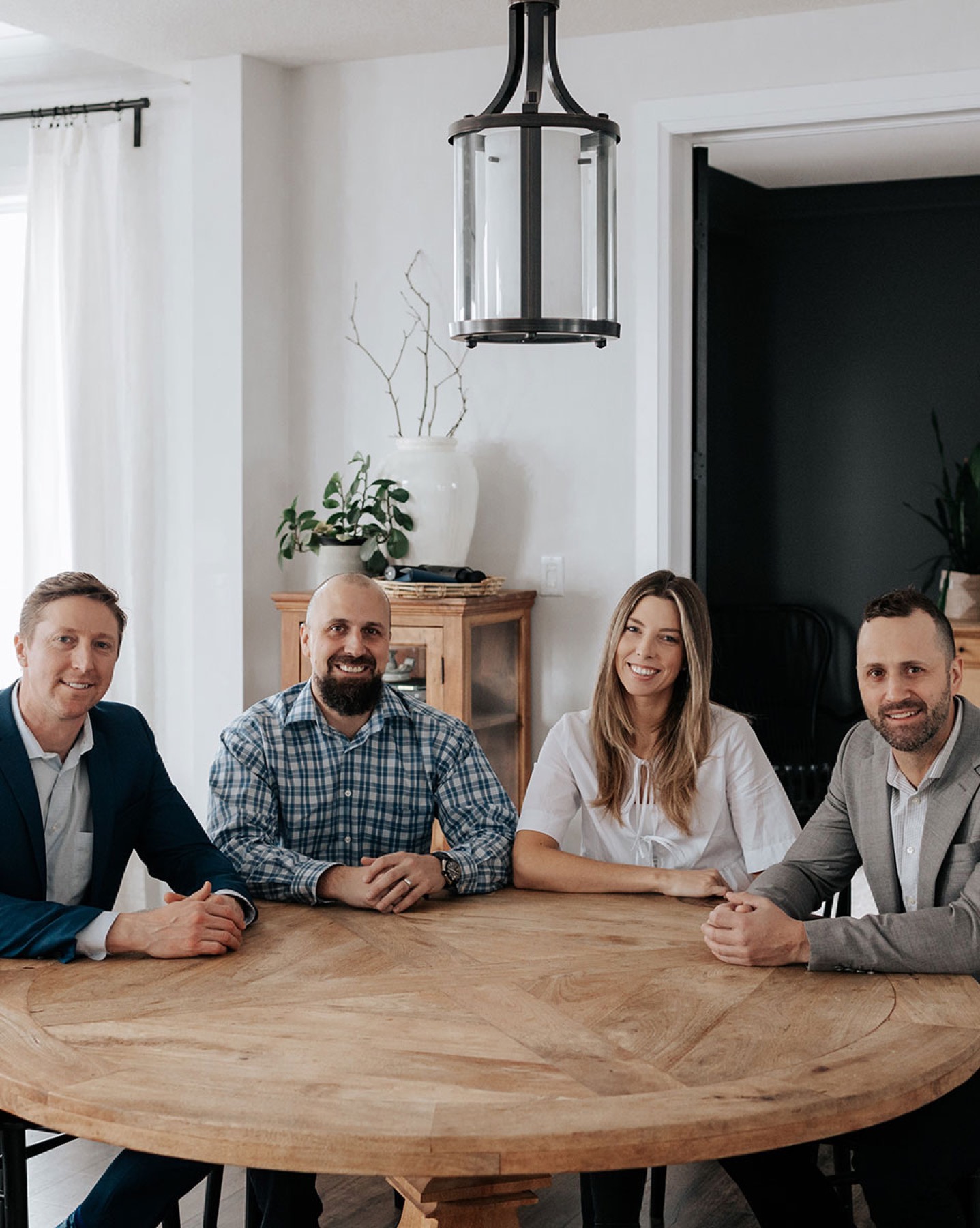 The CVE Mortgage Group team, Colin, Brendan, Leah and Derek, around a table in their office