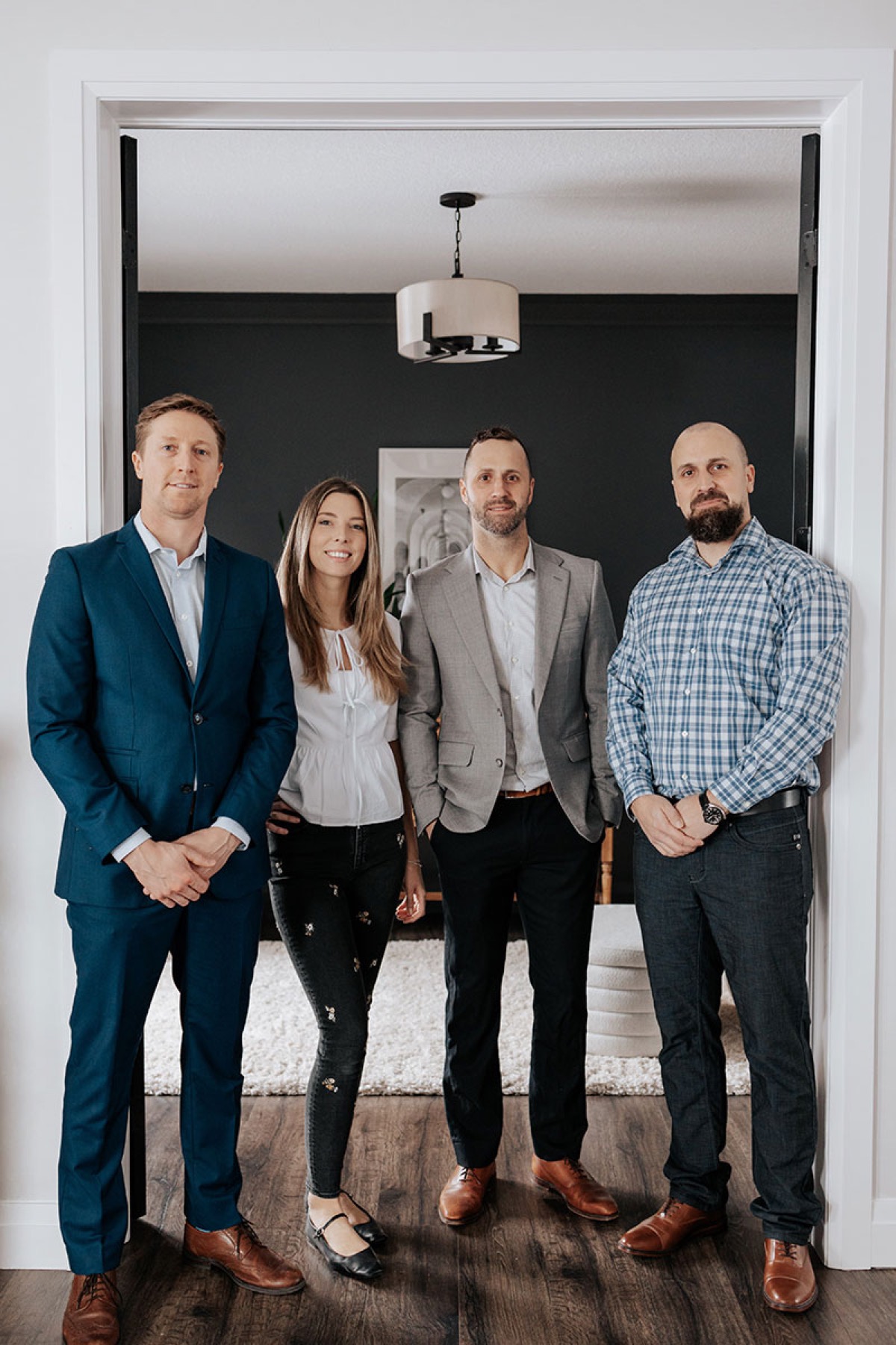 Colin, Leah, Derek and Brendan standing together in a doorway