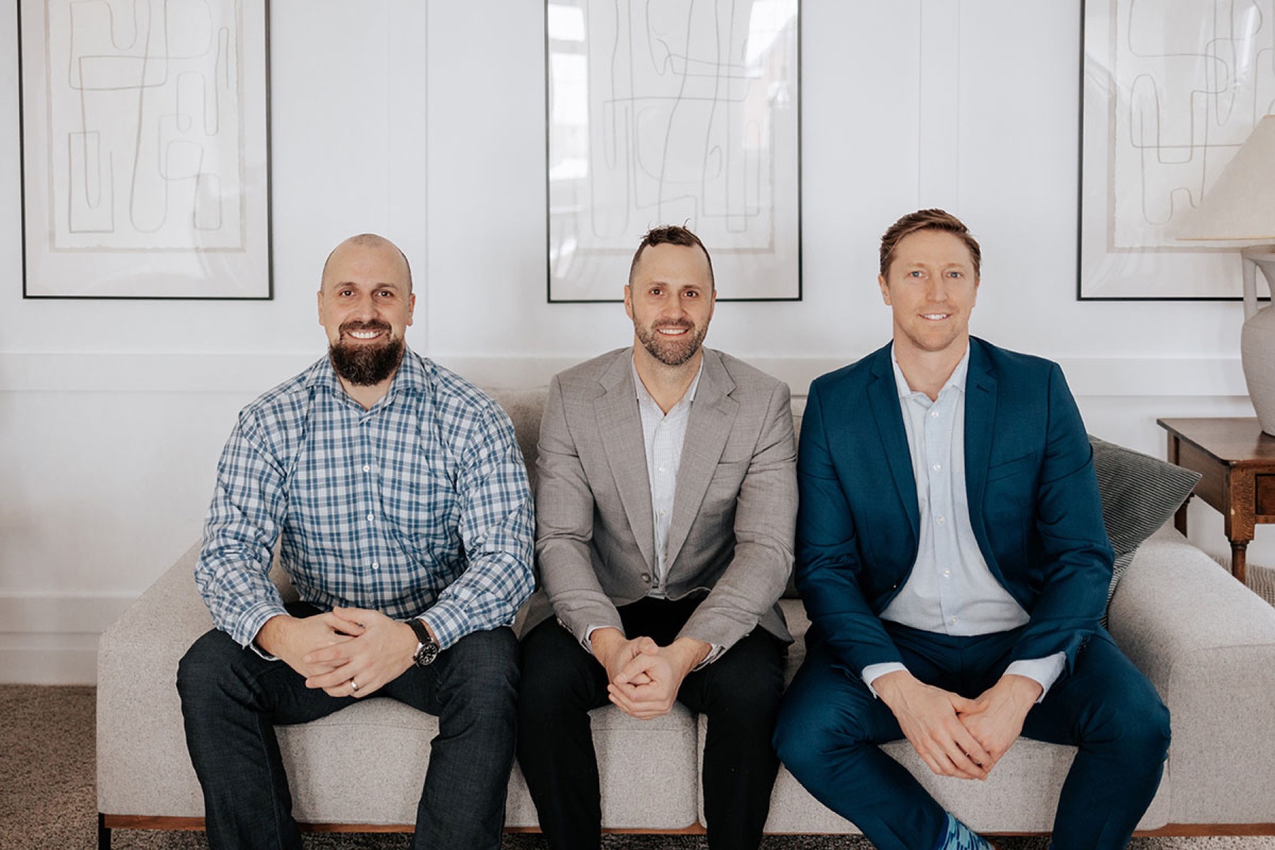 Derek, Colin and Brendan seated together on a sofa in the CVE office